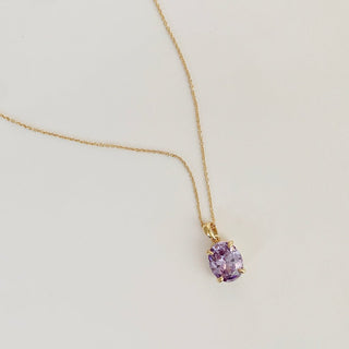 Dainty Confection Necklace with iridescent purple crystal pendant, perfect for layering or enhancing deep necklines.