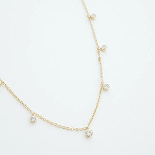 Crystal Stardust Necklace with shimmering tiny crystal charms on a delicate adjustable gold chain.
