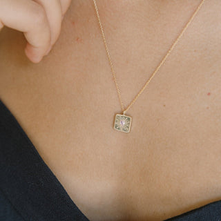 Gold necklace featuring a square pendant with a pink crystal designed for layering, adjustable length of 18" to 21".