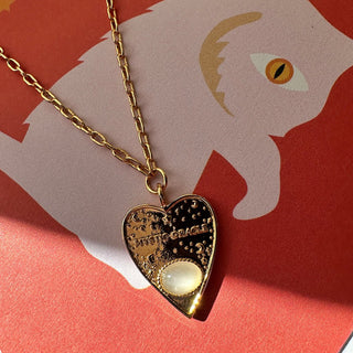 Gold Mystic Oracle Pendant with moonstone charm on a chain, perfect for Ouija board enthusiasts.
