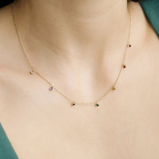 Delicate Rainbow Crystal Stardust Necklace with gold chain and shimmering crystal charms, perfect for layering.
