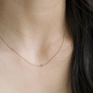 Minimalist Solo Bezel Necklace featuring a tiny cubic zirconia crystal on a delicate gold chain.