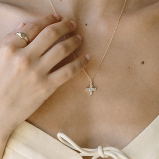 Star Crossed Necklace featuring a tiny moonstone on a delicate crossed pendant, perfect for layering.