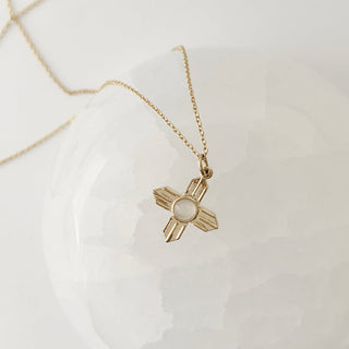 Star Crossed Necklace featuring a tiny moonstone in a crossed pendant, perfect for layering and adding vintage charm.