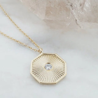 Sunbeam Pendant Necklace with a crystal in an octagon, symbolizing good luck and cosmic balance.
