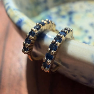 Gold-tone Bluebell Crystal Hoop Earrings, shown close up.