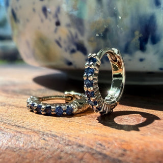 Gold-tone Bluebell Crystal Hoop Earrings, shown close up.