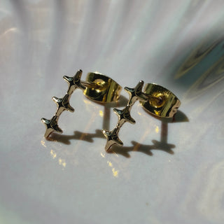Gold-tone Starlight Wand Earrings, shown close up.