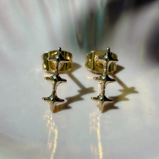 Gold-tone Starlight Wand Earrings, shown close up.