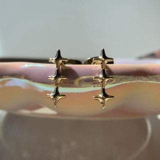 Gold-tone Starlight Wand Earrings, shown close up.