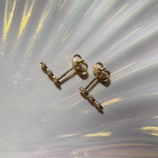 Gold-tone Starlight Wand Earrings, shown close up.