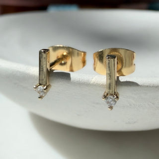 Gold-tone Crystal Matchstick Stud Earrings, shown close up.
