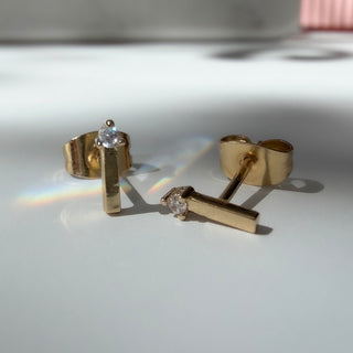 Gold-tone Crystal Matchstick Stud Earrings, shown close up.