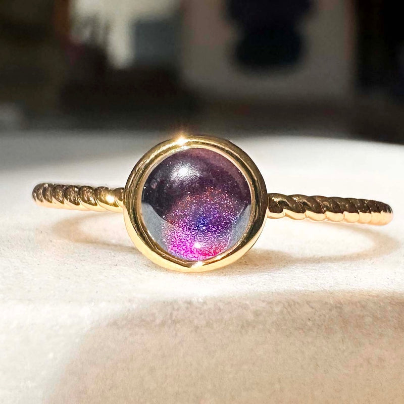 Close-up of Baby Twist Mood Ring featuring a colorful mood stone and twisted gold band, perfect for stacking or solo wear.