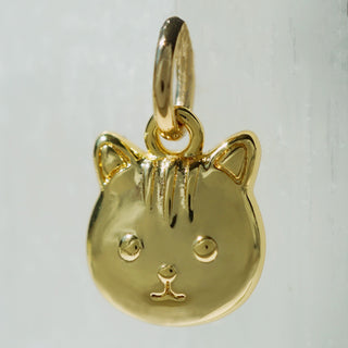 Gold critter-shaped pendant on a light gray background
