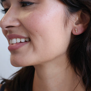 Honeycat Crystal Matchstick Stud Earrings worn by a model.