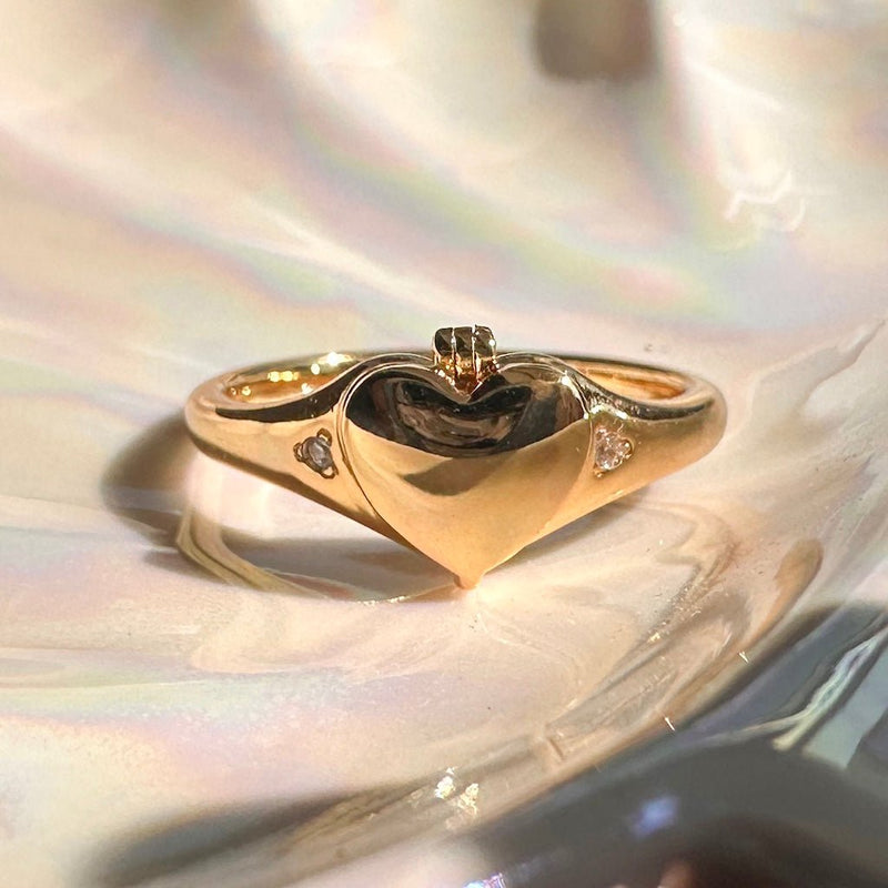 Dainty heart locket ring in shiny gold, featuring a tiny photo compartment, perfect for everyday wear and a touch of sweetness.