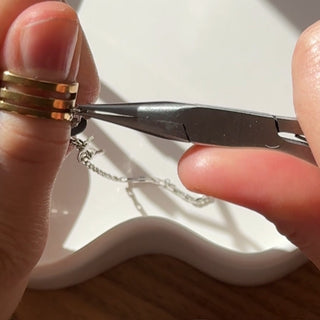 how to use a jump ring opener to add charms to your necklace or bracelet