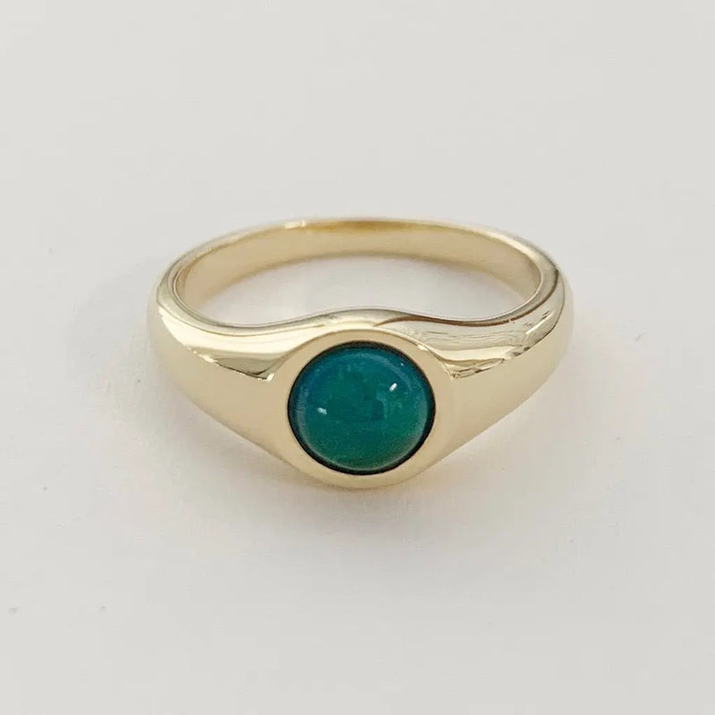 Dainty gold signet mood ring featuring a color-changing turquoise stone, perfect for stacking or wearing solo.
