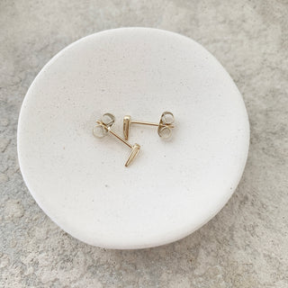 Gold-tone Tusk Droplet Stud Earrings, shown close up.